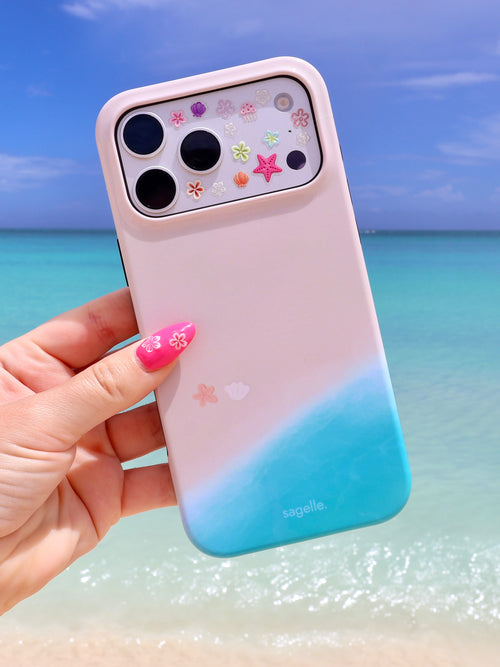 Sagelle beachin iPhone case with beach shoreline design held in front of a caribbean beach